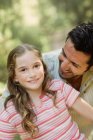 Father looking at daughter smiling — Stock Photo