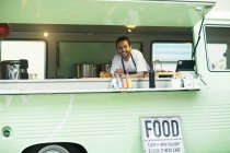 Business owner at van food stall hatch — Stock Photo
