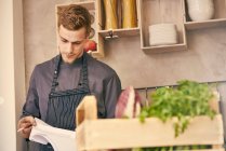 Chef looking at paperwork — Stock Photo