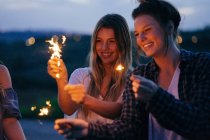 Friends playing with sparklers — Stock Photo
