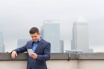 Hombre de negocios mirando el teléfono inteligente - foto de stock