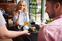 Waitress serving lunch to couple — Stock Photo