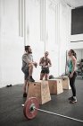 Friends chatting in cross training gym — Stock Photo