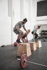 Friends jumping onto fitness boxes — Stock Photo