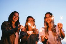 Friends playing with sparklers — Stock Photo