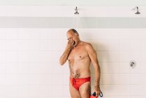 Homem usando chuveiro de piscina — Fotografia de Stock