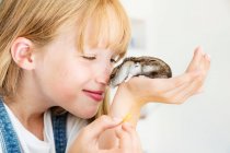 Girl feeding hamster — Stock Photo