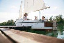 Three friends relaxing on sailing boat — Stock Photo