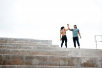 Man and woman at top of steps — Stock Photo