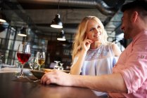 Couple chatting at restaurant table — Stock Photo