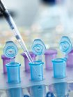 Pipetting sample into vial for testing — Stock Photo