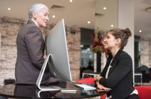 Mature businesswoman and female colleague — Stock Photo