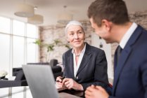 Businesswoman meeting male colleague — Stock Photo