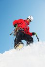 Mid adult man climbing on snow — Stock Photo