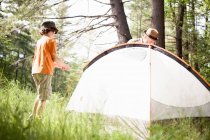 Father and son pitching tent — Stock Photo