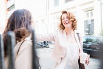 Two women laughing at street — Stock Photo