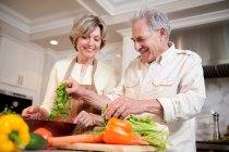 Couple d'âge mûr préparer une salade — Photo de stock