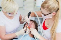 Dentists working on patients teeth — Stock Photo