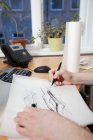 Architect sketching at desk — Stock Photo