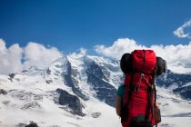 Backpacker admirando montanhas nevadas — Fotografia de Stock