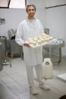 Worker at a cheese dairy — Stock Photo