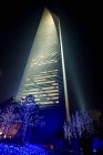 Skyscraper lit up at night — Stock Photo