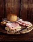 Ham and bread on cutting board — Stock Photo