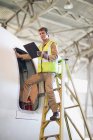 Aircraft worker checking airplane — Stock Photo