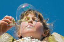 Girl blowing bubble — Stock Photo