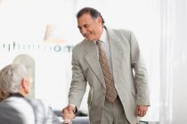 Businessman shaking colleague hand — Stock Photo