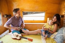 Parents and son resting in trailer home — Stock Photo