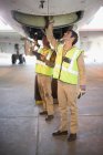 Trabalhadores de aeronaves verificando avião — Fotografia de Stock