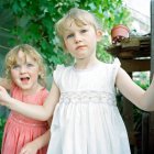 Two little girls in greenhouse — Stock Photo