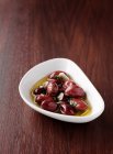 Dish of olives in oil — Stock Photo