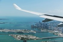 Airplane wing over Miami — Stock Photo