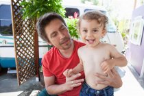 Father holding smiling son — Stock Photo