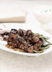 Meat kebabs and herbs — Stock Photo