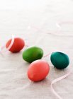 Easter eggs with ribbon on fabric — Stock Photo
