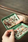 Male hands holding tackle box — Stock Photo