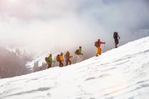 Cross country skiers going uphill — Stock Photo