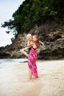 Дівчина, що носить брата на пляжі — стокове фото