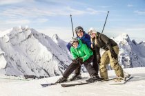 Улыбающиеся лыжники смотрят в камеру — стоковое фото