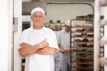 Chef smiling in kitchen — Stock Photo