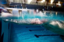 Blurred motion of male athlete swimming in pool — Stock Photo