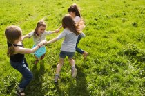 Girls playing in circle outdoors — Stock Photo