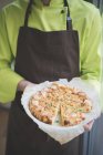 Waiter carrying plate of frittata — Stock Photo
