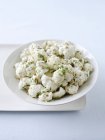 Pickled cauliflower with green in bowl — Stock Photo