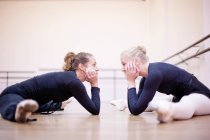 Teacher and ballerina practicing floor pose — Stock Photo