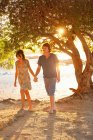 Couple walking barefoot in park — Stock Photo