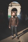 Young bearded man by arch — Stock Photo